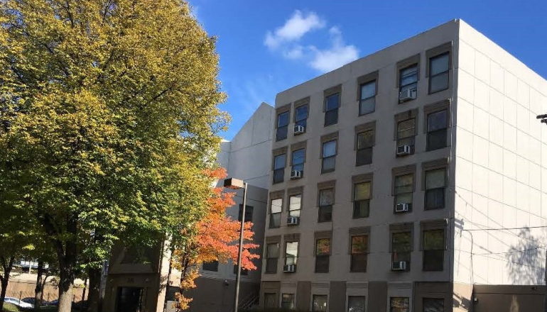 Corcoran Place Apartments brick exterior & trees