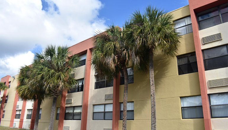 Cutler Meadows Glen Apartments exterior with palm trees