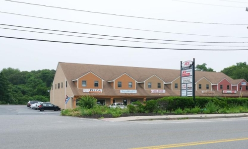 Wooded area behind plaza will be site of development