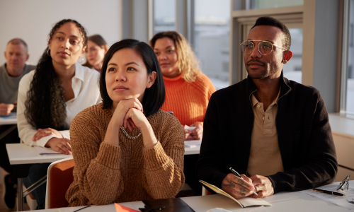 Folks attending a class and taking notes.