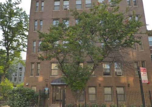 Corcoran Place Apartments brick exterior & trees